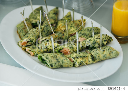 A wide variety of snacks on the table for guests. Shrimp, boiled pork, various types of meat and other products 89169144