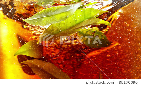 Detail of rotating tea leaves in water twister. Detail of rotating tea leaves in water twister. 89170096