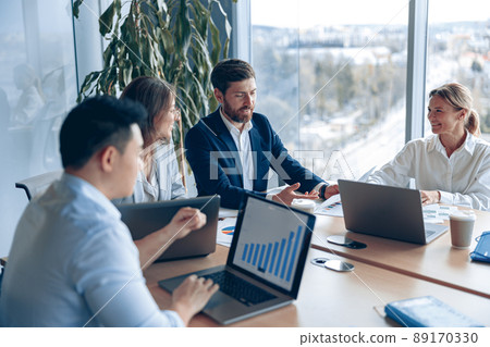 Creative business team working on project in modern office with panoramic view 89170330