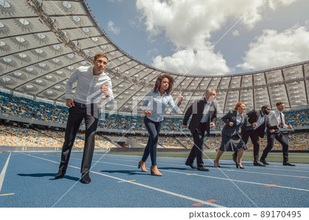 Side view of lined up business people on race track Side view of lined up business people on race track 89170495