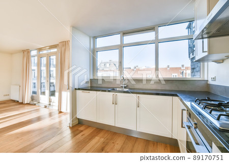 Nice kitchen with white kitchen set and parquet floor 89170751