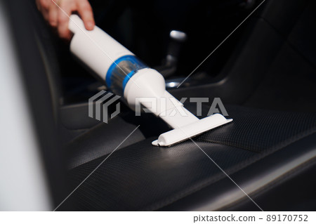 self-service car wash. person vacuuming car cabin after washing  89170752