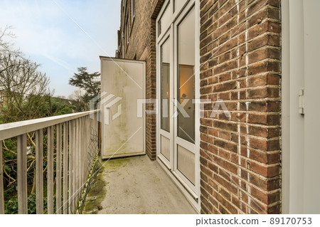 Balcony with concrete floor with metal fence and metal drill Balcony with concrete floor with metal fence and metal drill 89170753