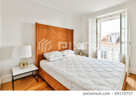 Luxury bedroom design with wooden bed and snow-white mattress Luxury bedroom design with wooden bed and snow-white mattress 89170757