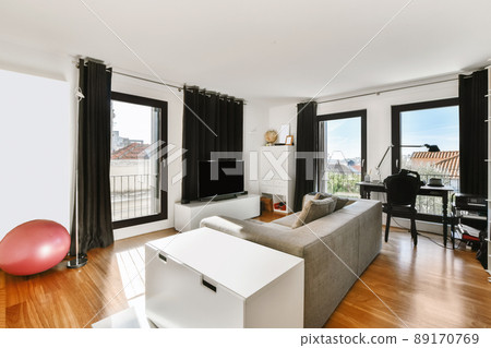 Lovely little living room with grey sofa in daylight Lovely little living room with grey sofa in daylight 89170769