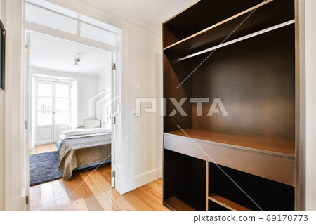 Luxury room design with large black wooden wardrobe and wooden floor Luxury room design with large black wooden wardrobe and wooden floor 89170773