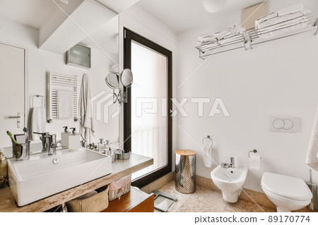 Lovely bathroom with a square sink and toilet Lovely bathroom with a square sink and toilet 89170774