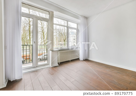 The interior of a stylish room with a window and curtains 89170775