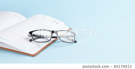 Notepad over blue background 89170913
