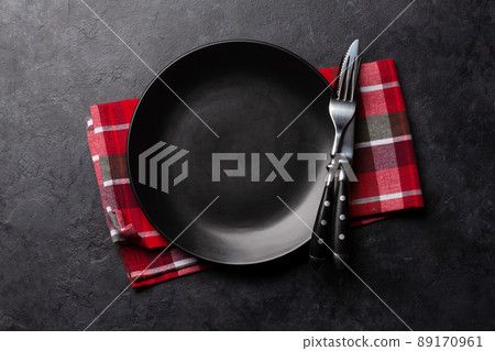 Empty plate and silverware on stone table Empty plate and silverware on stone table 89170961