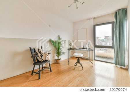 Workplace with a globe on the table next to the window and a view of the city Workplace with a globe on the table next to the window and a view of the city 89170974