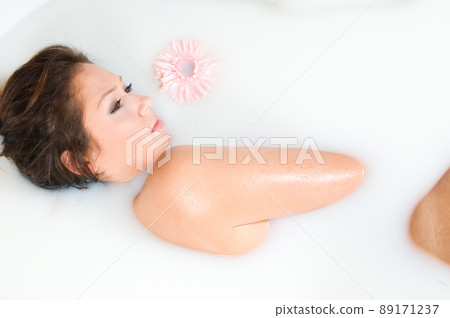 beautiful woman relaxing in milk bath beautiful woman relaxing in milk bath 89171237