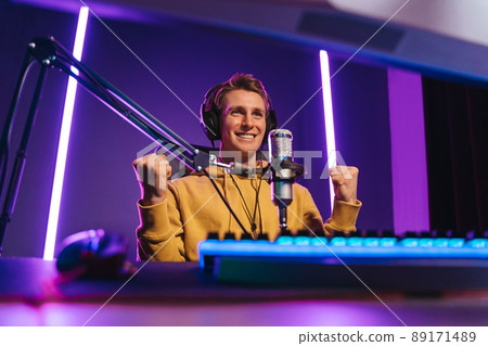 Cheerful gamer streamer just won esport multiplay competition 89171489