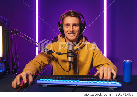 Happy pro gamer streaming live video while enjoying the game Happy pro gamer streaming live video while enjoying the game 89171495