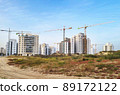 City construction among desert dunes. Building yard of Housing construction of houses in a new area of the city Holon in Israel 89172122