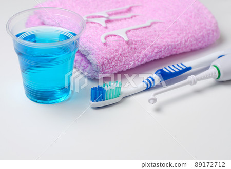 Dental hygiene. Toothbrush, mouthwash, pink towel, dental floss, oral irrigator 89172712