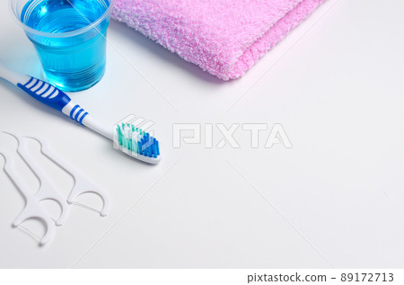 Dental hygiene. Toothbrush, mouthwash, pink towel, dental floss. Dental hygiene. Toothbrush, mouthwash, pink towel, dental floss. 89172713