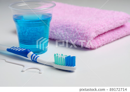 Dental hygiene. Toothbrush, mouthwash, pink towel, dental floss. 89172714