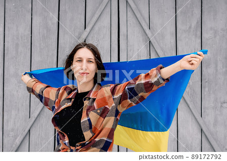 Girl holds the state flag of Ukraine 89172792