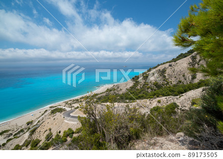 Gialos beach, narrow road and small island in the sea. Seascape, view from above. Ionian Sea, Lefkada island, Greece. Amazing blue sea water and exotic wild beach. 89173505