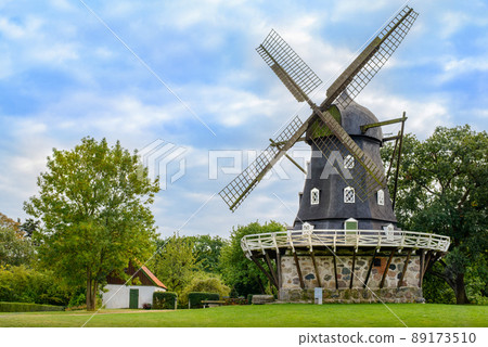 View of Old Windmill 'Slottsmollan' in the Kungsparken Park with beautiful clouds in the sky in Malmo, Sweden 89173510