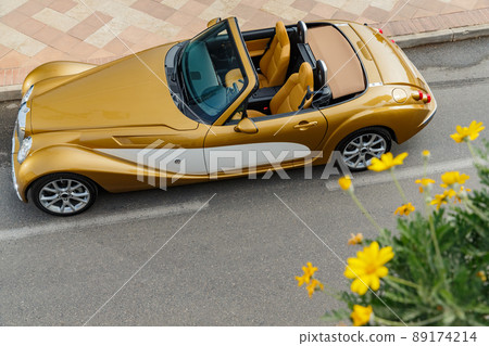 Exclusive vintage car is standing on narrow small streets, replica on the famous convertible car in French Riviera, Cap Ferrat, retro type, gold color, roadster, cote dazur 89174214