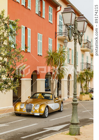 Exclusive vintage car is standing on narrow small streets, replica on the famous convertible car in French Riviera, Cap Ferrat, retro type, gold color, roadster, cote dazur 89174215