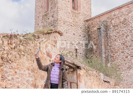 Latin Honduran video call and selfie photography from local tourism in Buitrago de Lozoya.  89174315