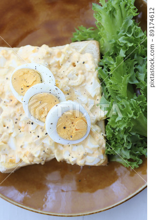Open sandwich with lots of egg on top 89174612