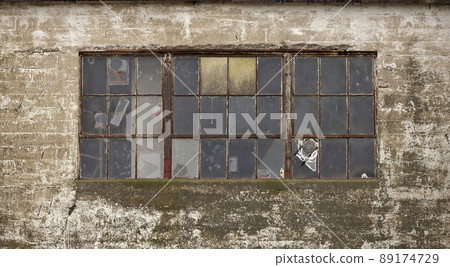 Old Broken Windows on an old Industrial Grain Silo Old Broken Windows on an old Industrial Grain Silo 89174729