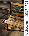 A wooden bench, seen on the streets of Rome 89174795