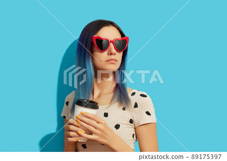 Hipster woman with blue hair holding paper cup 89175397
