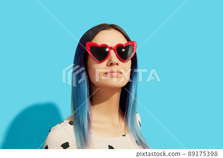 Hipster woman with blue hair wearing sunglasses. Happy caucasian girl looking up 89175398
