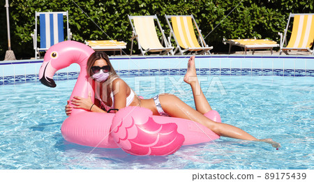 Beautiful tourist woman with corona virus mask and swan 89175439