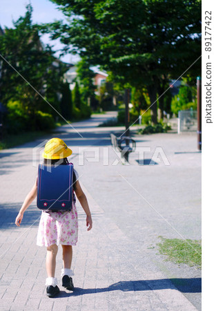 一年級學生的入學第一天。一個背著書包走路上學的孩子的背影。 89177422