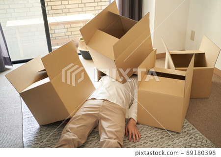 Asian man buried in a cardboard box 89180398