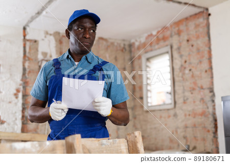 Foreman inspecting rooms and taking notes during renovation 89180671