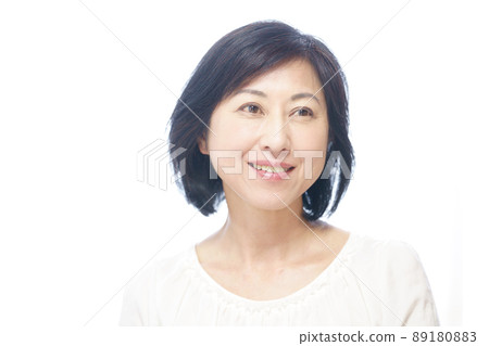 一個穿著白襯衫的微笑中年婦女 89180883