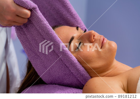 Relaxing massage. European woman getting head massage in spa salon, side view Relaxing massage. European woman getting head massage in spa salon, side view 89181212