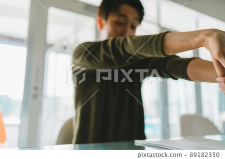 Men doing wrist stretches 89182350