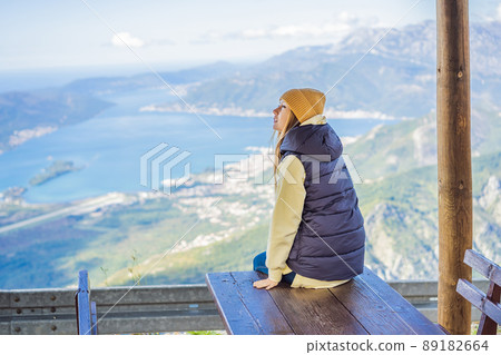 Woman tourist enjoys the view of Kotor. Montenegro. Bay of Kotor, Gulf of Kotor, Boka Kotorska and walled old city. Travel to Montenegro concept. Fortifications of Kotor is on UNESCO World Heritage Woman tourist enjoys the view of Kotor. Montenegro. Bay of Kotor, Gulf of Kotor, Boka Kotorska and walled old city. Travel to Montenegro concept. Fortifications of Kotor is on UNESCO World Heritage 89182664