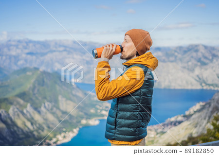 Man tourist enjoys the view of Kotor. Montenegro. Bay of Kotor, Gulf of Kotor, Boka Kotorska and walled old city. Travel to Montenegro concept. Fortifications of Kotor is on UNESCO World Heritage List Man tourist enjoys the view of Kotor. Montenegro. Bay of Kotor, Gulf of Kotor, Boka Kotorska and walled old city. Travel to Montenegro concept. Fortifications of Kotor is on UNESCO World Heritage List 89182850
