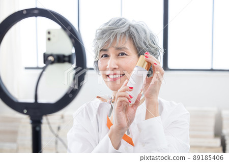 Senior woman Senior woman shooting a video on her smartphone Senior woman Senior woman shooting a video on her smartphone 89185406