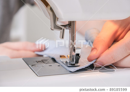 A man sews clothes on sewing machine. Hobbies A man sews clothes on sewing machine. Hobbies 89185599
