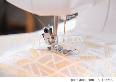 A man sews clothes on sewing machine. Hobbies A man sews clothes on sewing machine. Hobbies 89185600