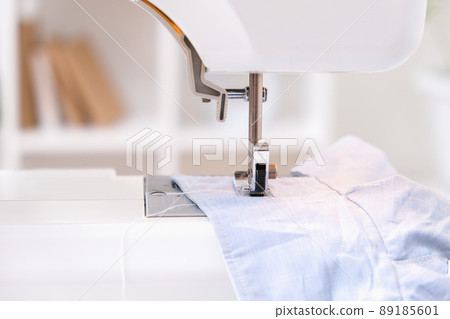 A man sews clothes on sewing machine. Hobbies 89185601