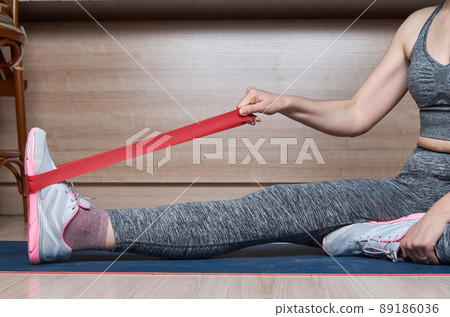 Resistance band exercise at home. Woman doing pilates workout Resistance band exercise at home. Woman doing pilates workout 89186036