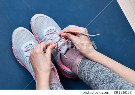 Sports woman tying her shoelaces 89186038