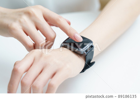 Woman wearing a smart watch 89186135