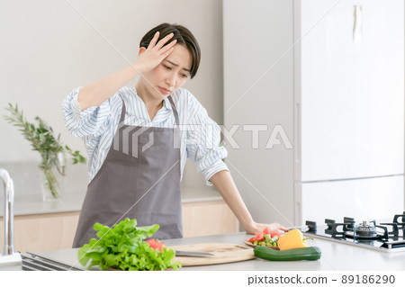 Kitchen woman headache tired fever 89186290